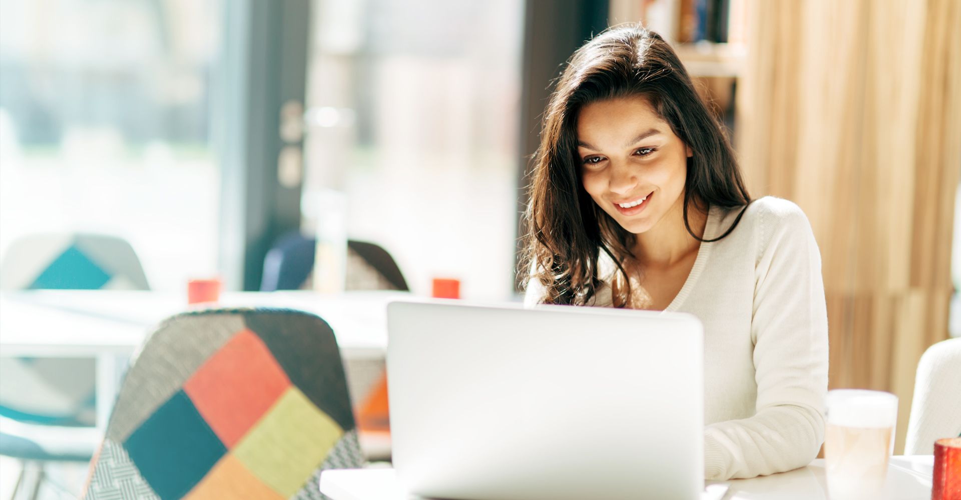 girl at table looking at financing offers for flooring
